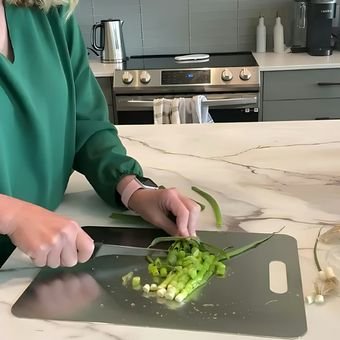 Linda chopping vegetables on a Katori board